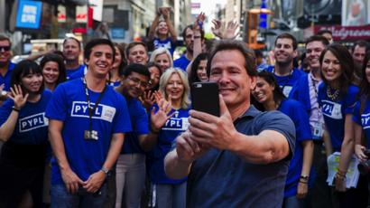 Paypal CEO Dan Schulman (C) celebrates with employees after the company's relisting on the Nasdaq in New York, July 20, 2015.