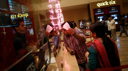 A cinema-goer asks for directions at the ticket counter of a PVR Multiplex in Mumbai