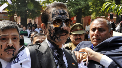 Subrata Roy with his face smeared in ink thrown by an unidentified man upon his arrival at the Supreme Court in New Delhi.