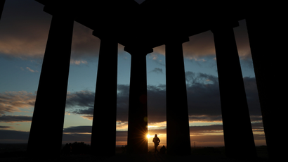 People watch the sunrise from Penshaw Monument, County Durham, Britain
