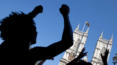 College students dance in front of Westminster Abbey in London. Olivette Otele this week became the first black woman professor of history in the UK.