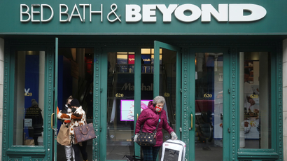 Masked shoppers walk out of a Bed Bath and Beyond store in Manhattan