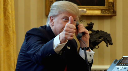 U.S. President Donald Trump gives a thumbs-up to reporters