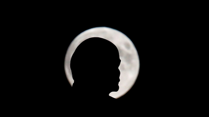 A full moon with the silhouette of a head