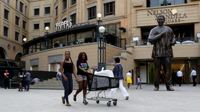 Shoppers push trolleys at an upmarket shopping mall in Sandton, Johannesburg, in this September 23, 2015 file photo.