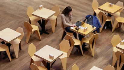 A woman uses a laptop at a cafe in the Central Universal Department Store (TsUM) in Kiev, Ukraine