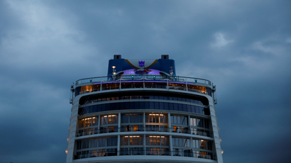 The rear cabins of a Royal Caribbean ship, the Quantum of the Seas, are shown in front of dark, cloudy skies during a "cruise to nowhere" in Singapore.