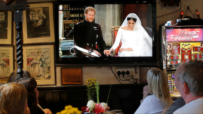 British tourists watch Britain's Prince Harry and Meghan Markle's wedding on a television at a restaurant in the British overseas territory of Gibraltar, historically claimed by Spain May 19, 2018.
