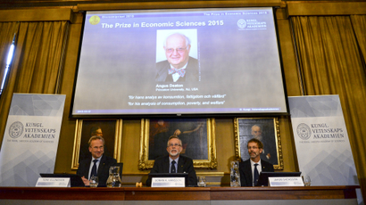 A picture of British economist Angus Deaton, winner of the 2015 economics Nobel Prize, is seen on a screen as Goran K. Hansson (C), permanent secretary for the Royal Swedish Academy of Sciences, and Tore Ellingsen (L), chairman of the prize committee, and Jakob Svensson, member of the Academy, address a news conference at the Royal Swedish Academy of Science, in Stockholm, Sweden October 12, 2015. Deaton won the 2015 economics Nobel Prize for "his analysis of consumption, poverty, and we