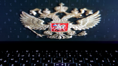 The Russian coat of arms over a laptop keyboard