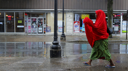 A Somali woman walks along a street in downtown Lewiston, Maine.