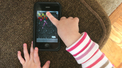 A child plays with a cell phone
