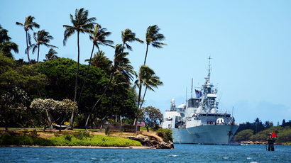 A frigate pulls into Pearl Harbor.