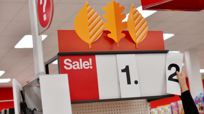 An employee alters the sale price of merchandise on a numerical sign at a Target store.