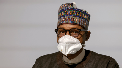 An image of Nigeria's president Muhammadu Buhari wearing a white face mask.