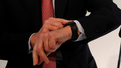 An executive looks at his watch