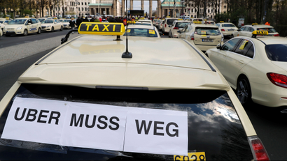 Cars a seen during a protest of licensed taxi drivers against a planned change of the passenger transport law in Berlin, Germany, April 10, 2019. The words read "Uber must go."