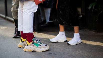 MILAN, ITALY - JANUARY 13: Guests wearing Balenciaga sneakers seen outside Dolce &amp; Gabbana during Milan Men's Fashion Week Fall/Winter 2018/19 on January 13, 2018 in Milan, Italy. (Photo by Christian Vierig/Getty Images)