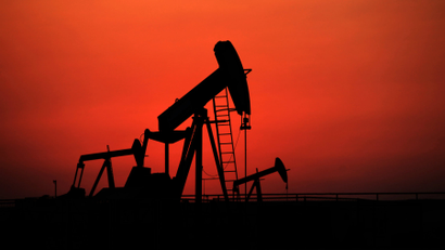 Oil pumps work at sunset in the desert oil fields of Sakhir, Bahrain