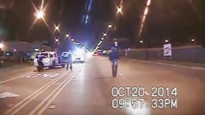 In this Oct. 20, 2014 frame from dash-cam video provided by the Chicago Police Department, Laquan McDonald, right, walks down the street moments before being shot by officer Jason Van Dyke in Chicago. Van Dyke, who shot McDonald 16 times, was charged with first-degree murder Tuesday, Nov. 24, 2015. (Chicago Police Department via AP)