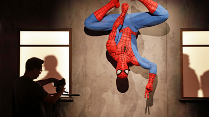 A life-size Spiderman replica hangs upside-down during a preview of the exhibit Marvel: Universe of Super Heroes at the Museum of Pop Culture (MoPOP), in Seattle.