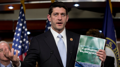 House Budget Committee Chairman Rep. Paul Ryan, R-Wis., holds up the 2014 Budget Resolution as he speaks during a news conference on Capitol Hill, Tuesday, March 12, 2013, in Washington.