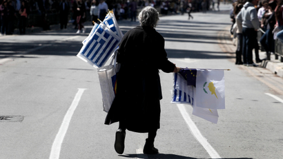A woman selling Greek and Cypriot flags
