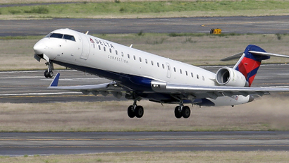 In this March 24, 2015 file photo, a Delta jet takes off from Seattle-Tacoma International Airport in SeaTac, Wash.