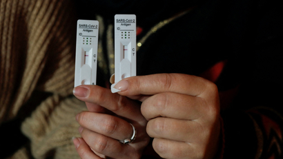 Women show their negative rapid test results after using COVID-19 self-test kits, in Malaga