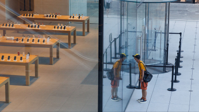 A person in front of an Apple Store in China