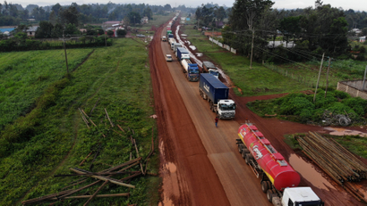 Parked trucks wait in a 10km queue to cross the Kenyan-Ugandan border from the town of Busia, Kenya November 14, 2020.