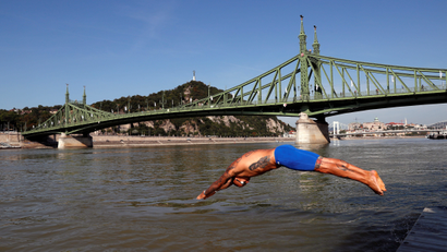 A swimmer dives into the Danube River on August 29, 2020.
