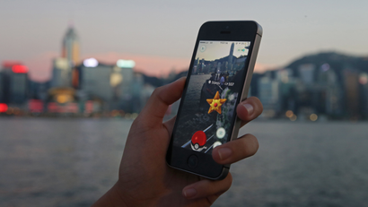 A fan maneuvers his smartphone as he plays "Pokemon Go" in Hong Kong, Monday, July 25, 2016. Pokemon fans used the app on Monday as it was released to both iPhone and Android users. (AP Photo/Kin Cheung)