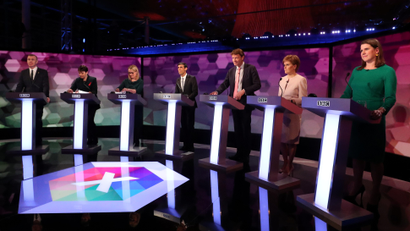 Seven party representatives for the UK general election on stage before a debate.