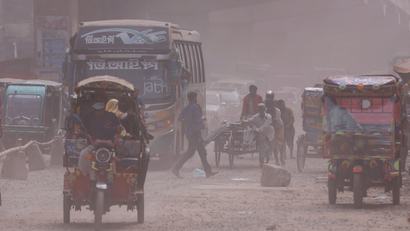 Vehicles are moving on a dusty road as air pollution worsens during winters in Tongi area of Gazipur