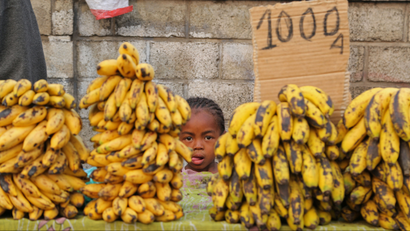 A girl stands behind her father's banana store in the city of Antananarivo, Madagascar, Wednesday, Oct. 23, 2013. Madagascar will hold elections on Friday that organizers hope will end political tensions that erupted in a 2009 coup and help lift the aid-dependent country out of poverty. The island nation in the Indian Ocean plunged into turmoil after Andry Rajoelina, the current president, forcibly took power from former President Marc Ravalomanana with the backing of the military. (AP Photo/Schalk van Zuydam
