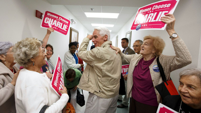 Former Florida Governor and Democratic gubernatorial candidate Charlie Crist (C) heads out of the Mid-County Senior Center, during a four-city bus campaign tour in Lake Worth, Florida November 3, 2014. Florida Republican Governor Rick Scott and Crist remain statistically tied in their bitterly fought campaign, according to a poll released on Monday, the eve of Election Day.