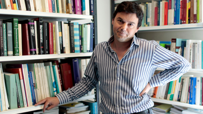Thomas Piketty, French economist behind Socialist party candidate Francois Hollande's plan to tax all income over one million euros ($1.3 million) per year at 75 percent, poses in his office in Paris April 11, 2012. At 40, Piketty is one of France's top economists and has won international acclaim for his pioneering work about income inequality worldwide. Picture taken April 11, 2012.