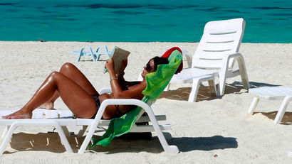 A tourist reads a book in Turatao Marine National Park off the Andaman Sea in southern Thailand's Satun province