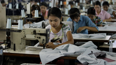 In this April 21, 2012 photo, young workers use sewing machines at a garment factory in Yangon, Myanmar. The European Union confirmed Monday, April 23, 2012, that it was suspending most of its sanctions against Myanmar to reward the country's recent wave of political reform. The suspension of trade sanctions could help revive the nation's industries, restoring some of the 80,000 garment industry jobs lost here over the past 10 years. (AP Photo/Sakchai Lalit)