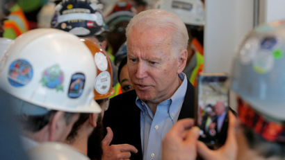Joe Biden talks with a worker at the Fiat Chrysler Automobiles Mack Assembly plant in Detroit