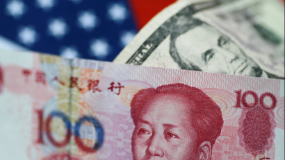U.S. Dollar and China Yuan notes are seen in this picture illustration