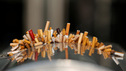 Extinguished cigarettes are seen in an ashtray at Shanghai Railway Station, China, December 23, 2013.