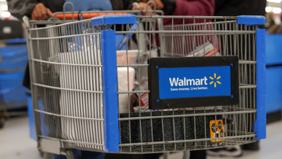 A customer pushes a shopping cart at a Walmart store