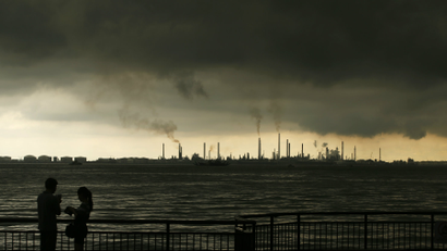 Storm clouds gather over Shell's Pulau Bukom oil refinery in Singapore.