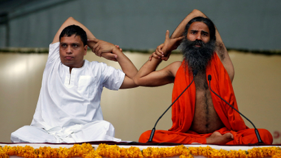 Yoga guru Baba Ramdev and Managing Director ofPatanjali Ayurved Acharya Balkrishna perform yoga during a four-day long camp ahead of International Yoga day, in Ahmedabad