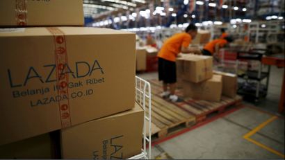 Employees at online retailer Lazada fill orders at the company's warehouse in Jakarta