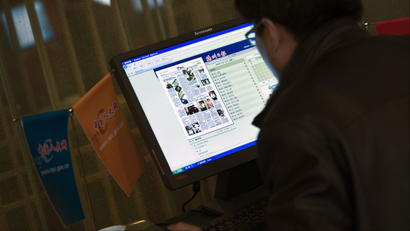A Chinese journalist browses internet news on the computer at the media center set up for the China's National People's Congress and Chinese People's Political Consultative Conference in Beijing, China, Wednesday, March 11, 2009. China's major internet companies say profits are up, despite the global economic crisis.