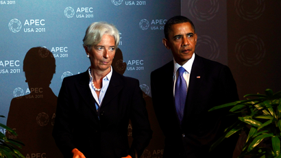 International Monetary Fund (IMF) Director Christine Lagarde (L) and U.S. President Barack Obama arrive for the first plenary meeting at the APEC Summit in Honolulu, Hawaii November 13, 2011.