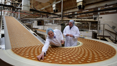 Design and Development Head Chef , Paul Courtney and Manufacturing Manager, Tom Kilcourse, pose for a photograph on a biscuit production line at the McVities factory in Stockport, northern England